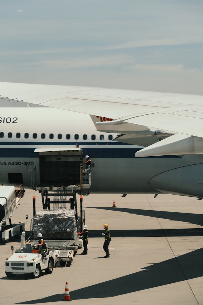 why-choose-us Airbus A330 being loaded with cargo on an airport runway, showcasing transportation logistics.