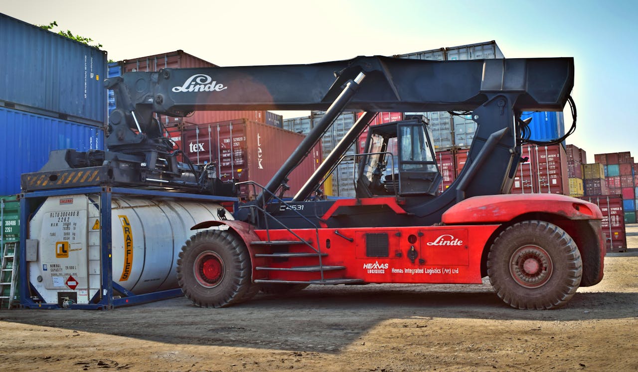 gallery-2 Forklift operating at a cargo yard, moving large containers efficiently.